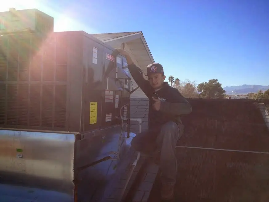 HVAC technician performing Air Duct Cleaning on a rooftop unit in Wyomissing